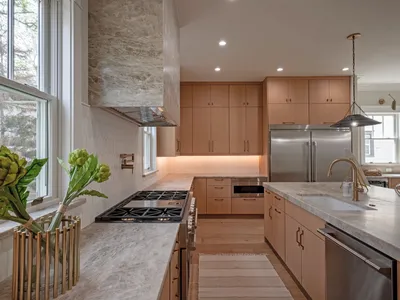 Gourmet kitchen detail with gas cooktop and statement range hood