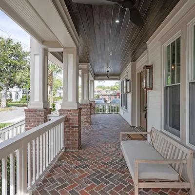 Covered brick front porch with classic Avondale street views