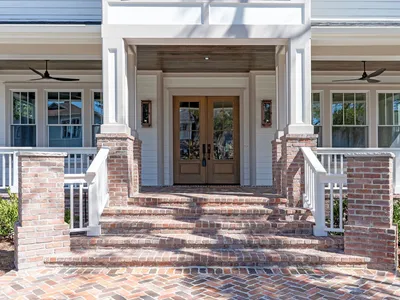 Brick front steps leading to the home's double entry doors