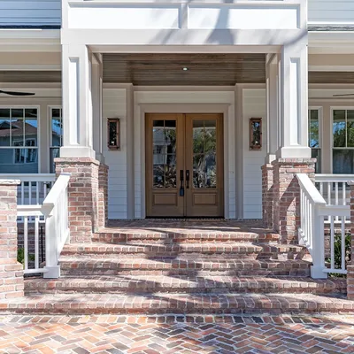 Brick front steps leading to the home's double entry doors